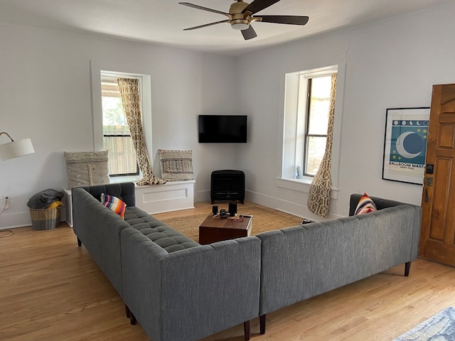 living room featuring a wealth of natural light, hardwood / wood-style floors, and ceiling fan