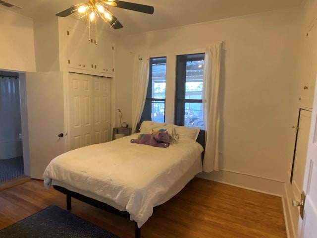 bedroom featuring hardwood / wood-style floors, a closet, and ceiling fan