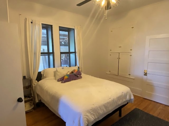 bedroom featuring ceiling fan and dark hardwood / wood-style flooring