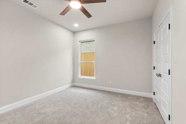 empty room with light carpet and ceiling fan