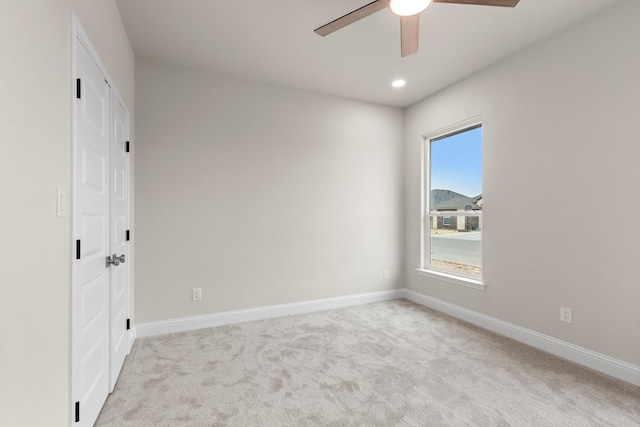 unfurnished bedroom with ceiling fan and light carpet