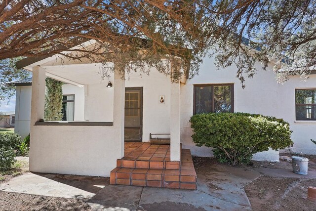 view of front of property with a patio area and stucco siding