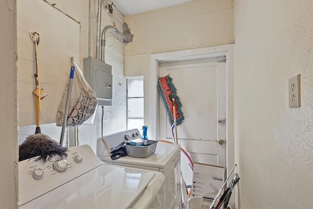 laundry room featuring a textured wall, laundry area, electric panel, and independent washer and dryer