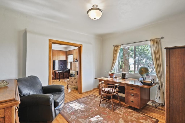 home office with light wood-style flooring