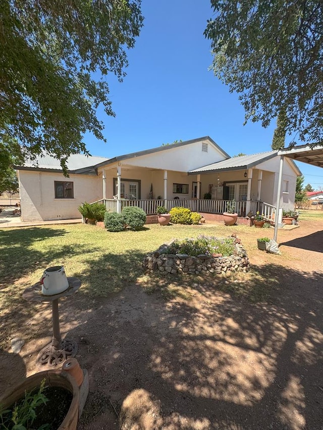 back of property featuring covered porch, metal roof, and an attached carport