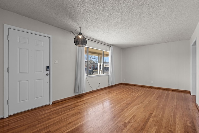 foyer featuring wood-type flooring and a textured ceiling