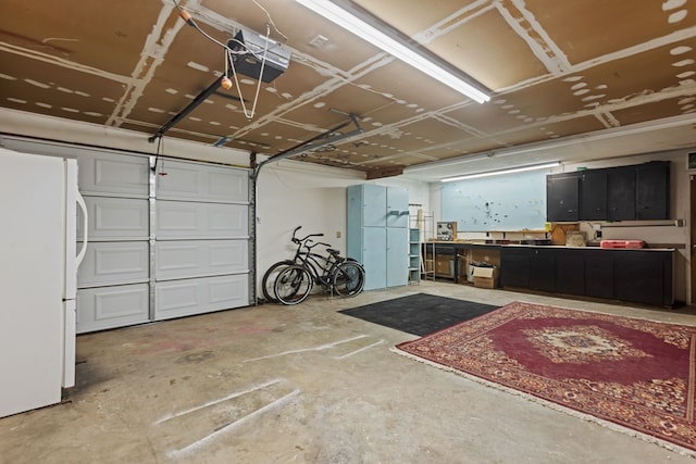 garage featuring a garage door opener and white fridge