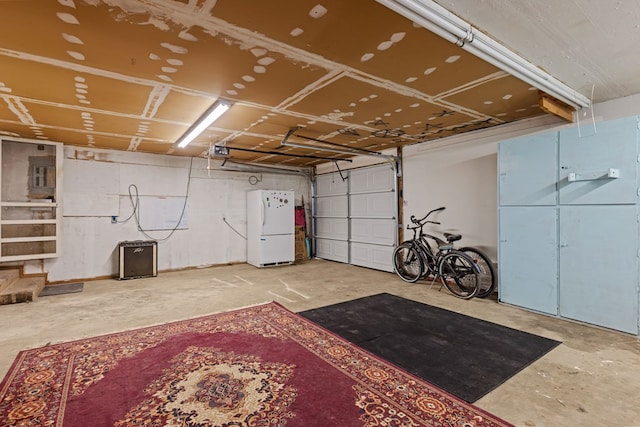 garage with white refrigerator and a garage door opener