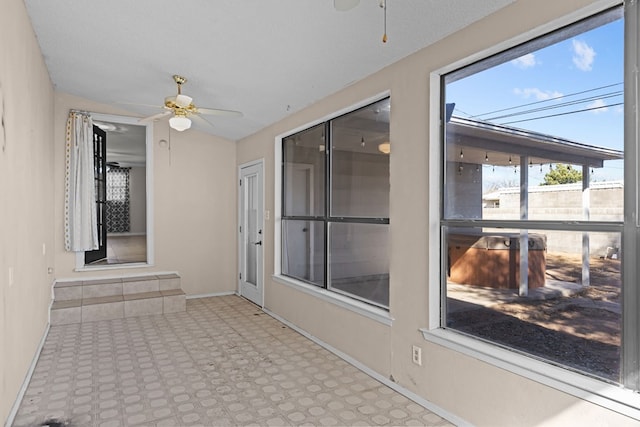 unfurnished sunroom with lofted ceiling and ceiling fan