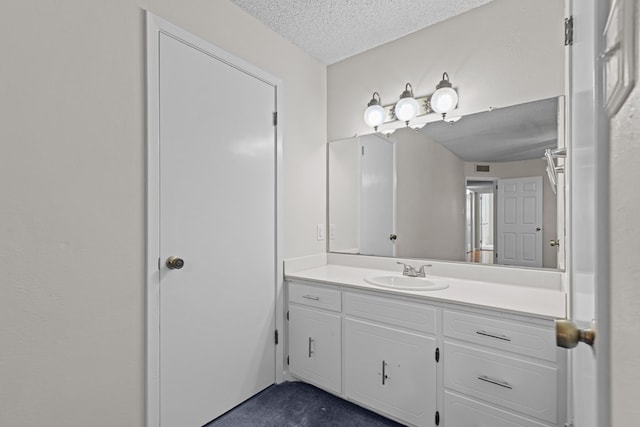 bathroom with vanity and a textured ceiling