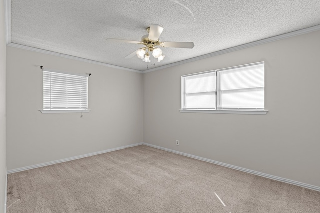 empty room with ornamental molding, light colored carpet, ceiling fan, and a textured ceiling