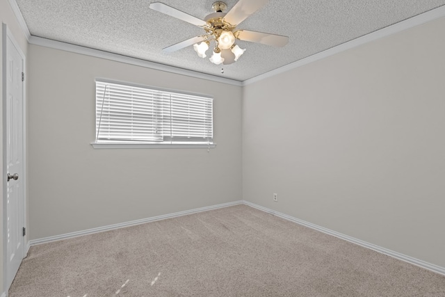 spare room featuring crown molding, ceiling fan, light carpet, and a textured ceiling