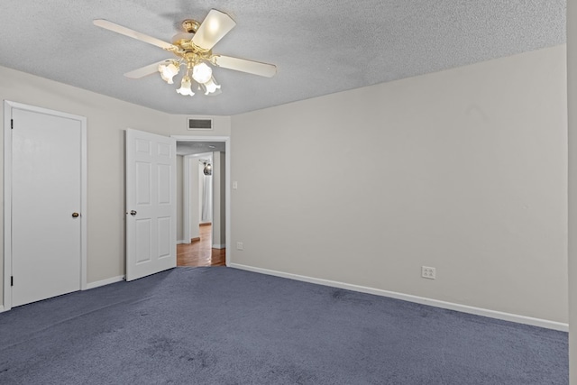 unfurnished bedroom featuring ceiling fan, a textured ceiling, and dark colored carpet