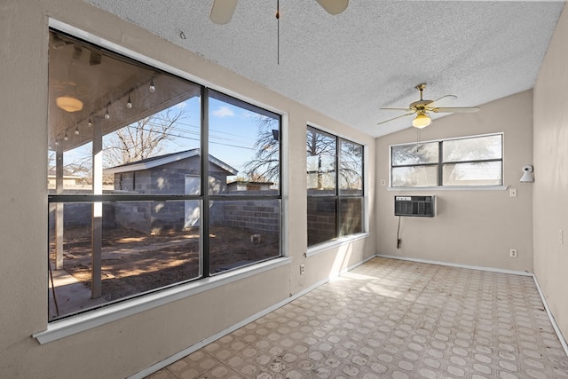 unfurnished sunroom featuring vaulted ceiling, a wall mounted AC, and ceiling fan