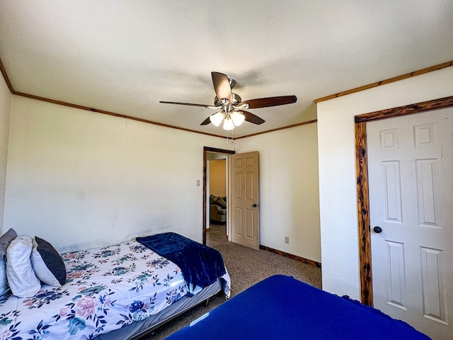 carpeted bedroom featuring baseboards, a ceiling fan, and crown molding