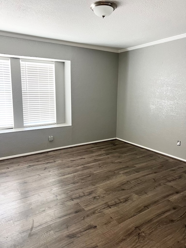 spare room featuring dark hardwood / wood-style flooring and crown molding