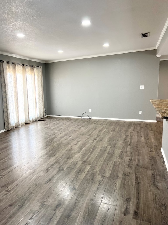 unfurnished living room with crown molding and hardwood / wood-style flooring