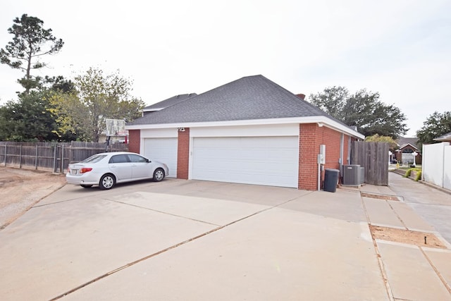 view of side of home with central AC unit