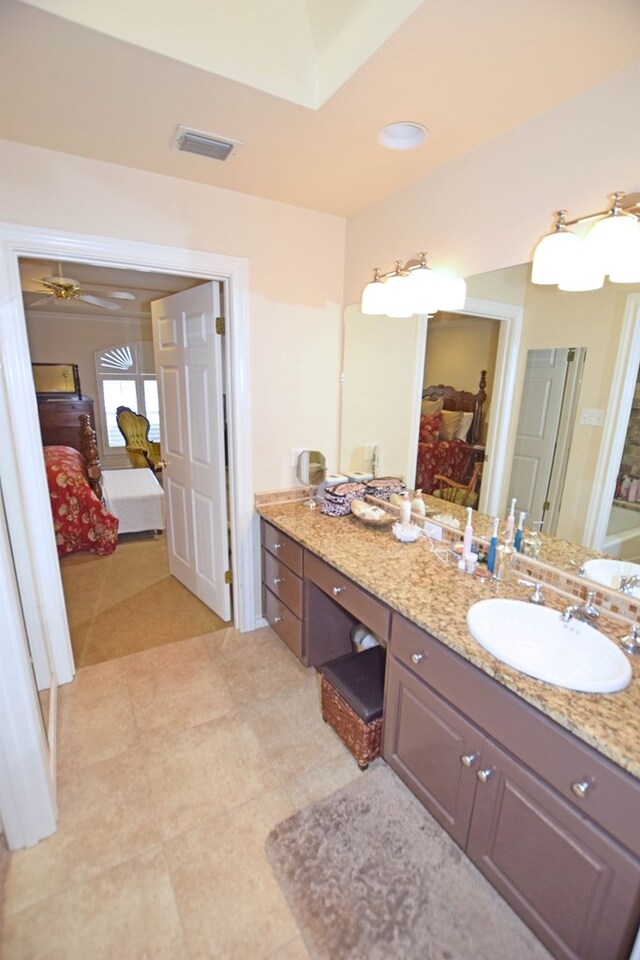 bathroom featuring tile patterned flooring, vanity, and ceiling fan