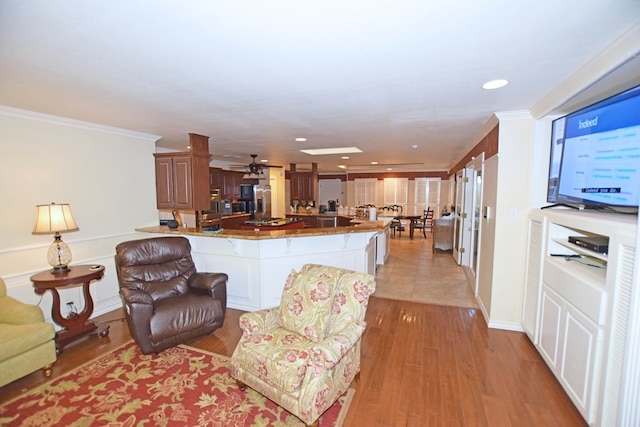 living room with light hardwood / wood-style floors and ornamental molding