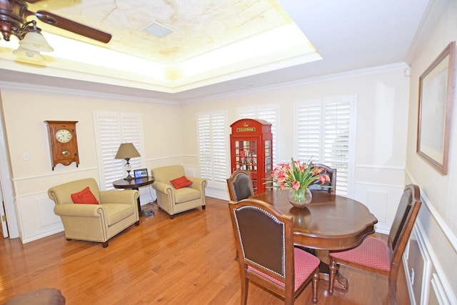 dining room featuring ceiling fan, wood-type flooring, and ornamental molding