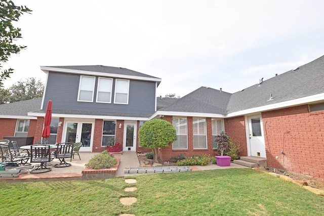 rear view of house with a patio area and a yard