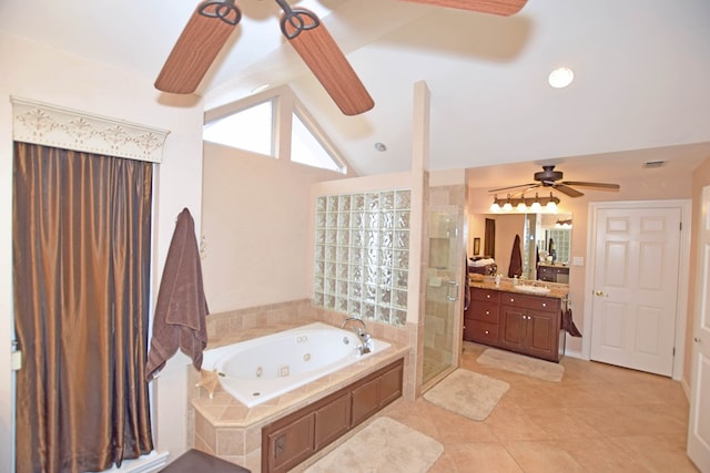 bathroom with tile patterned floors, vanity, independent shower and bath, and vaulted ceiling