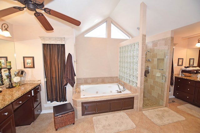 bathroom with tile patterned floors, vanity, independent shower and bath, and vaulted ceiling