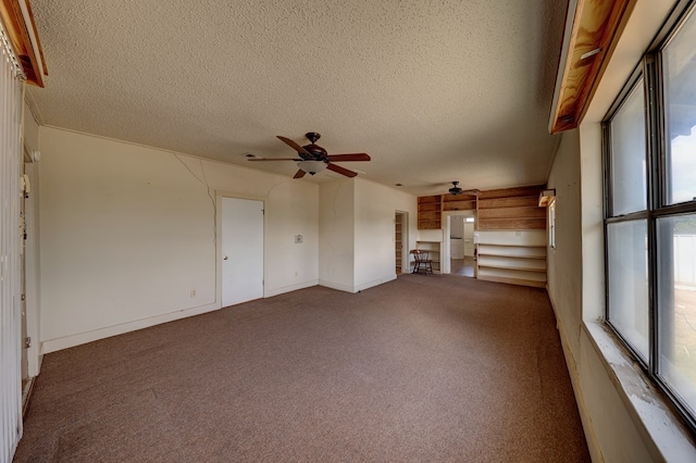 unfurnished living room featuring carpet, a textured ceiling, and ceiling fan