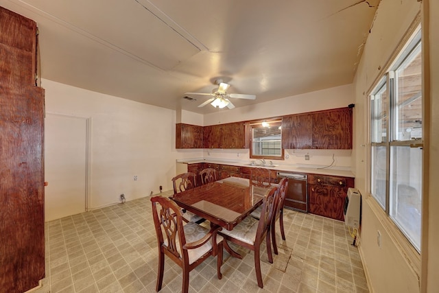 dining room featuring ceiling fan, sink, and heating unit