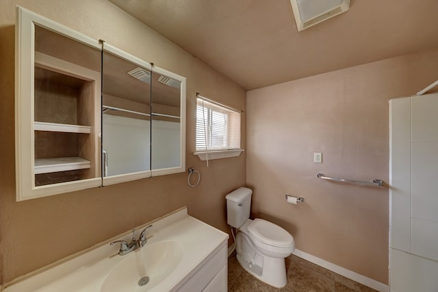 bathroom featuring tile patterned flooring, vanity, and toilet