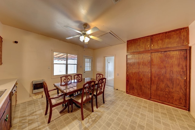 dining space with heating unit and ceiling fan