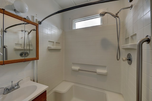 bathroom featuring vanity and tiled shower