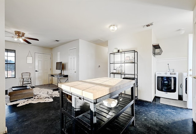 dining space featuring ceiling fan and washer and clothes dryer