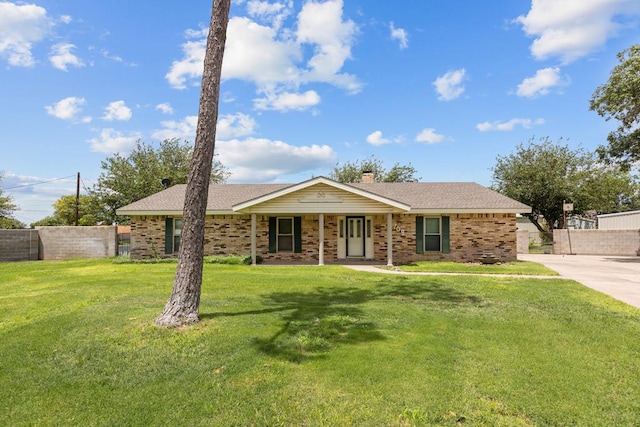 single story home with a porch and a front yard