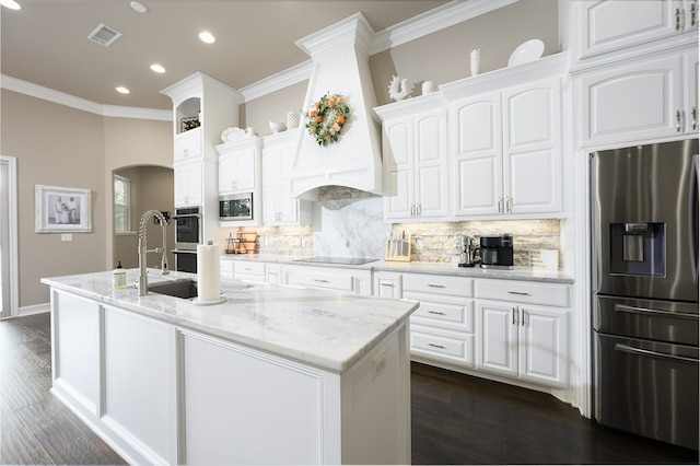 kitchen featuring light stone counters, ornamental molding, stainless steel appliances, dark wood-type flooring, and white cabinets