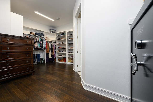 spacious closet with dark wood-type flooring