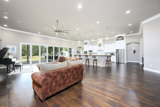 living room featuring dark hardwood / wood-style floors, ceiling fan, and ornamental molding