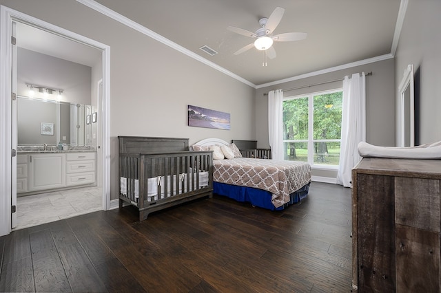 bedroom with dark hardwood / wood-style flooring, ensuite bathroom, ceiling fan, and crown molding