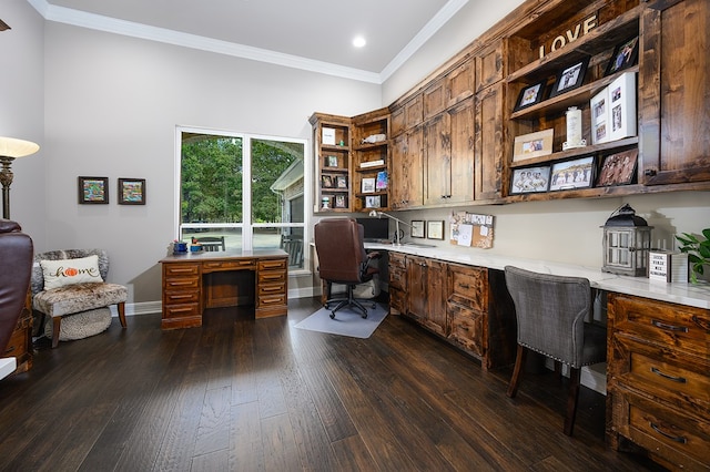 home office featuring crown molding, dark hardwood / wood-style flooring, and built in desk