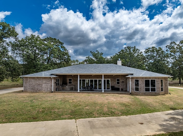 single story home with a patio area and a front lawn