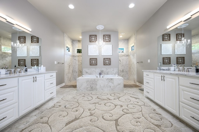 bathroom featuring vanity, shower with separate bathtub, and an inviting chandelier