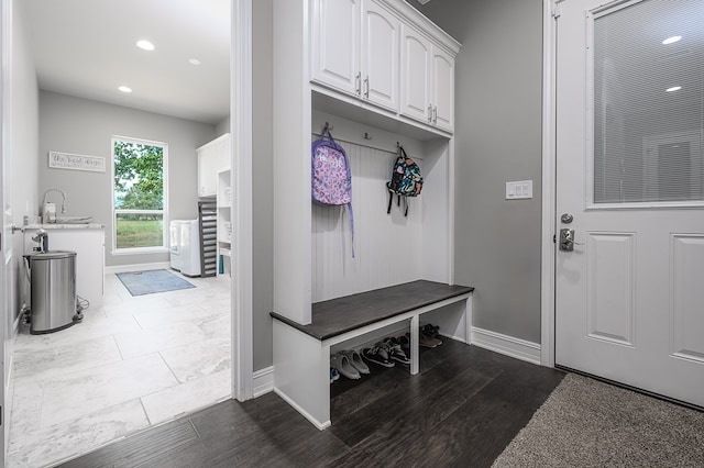 mudroom with hardwood / wood-style flooring and sink