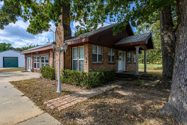 view of front of house with a garage and an outdoor structure