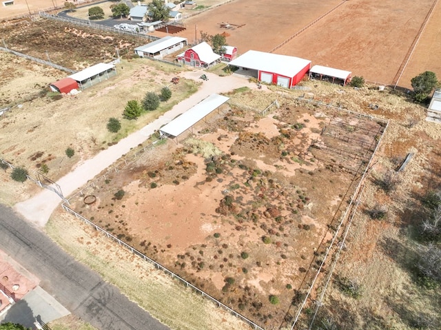 birds eye view of property with a rural view