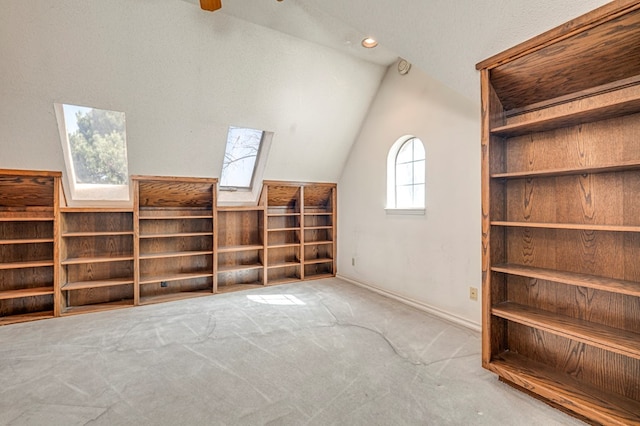 bonus room with vaulted ceiling with skylight and carpet floors