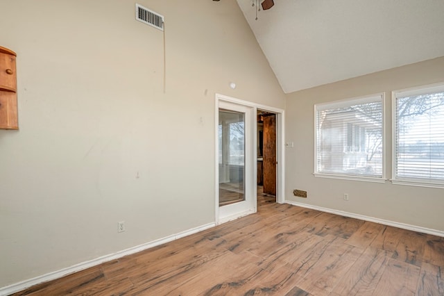 spare room featuring a ceiling fan, wood finished floors, visible vents, and baseboards