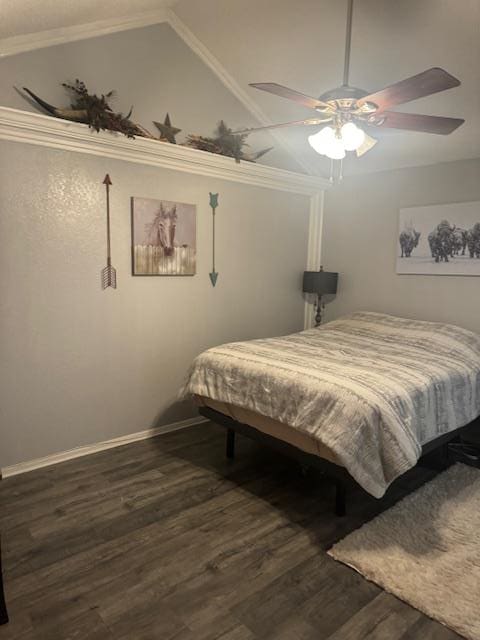 bedroom featuring ceiling fan, dark hardwood / wood-style flooring, ornamental molding, and vaulted ceiling