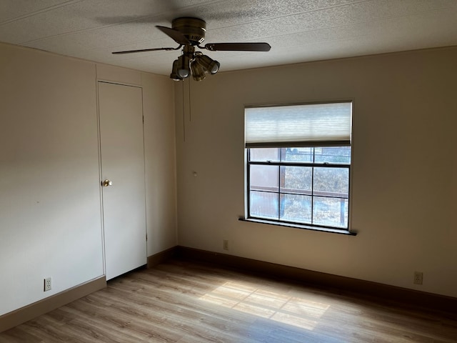 unfurnished bedroom featuring a closet, light hardwood / wood-style floors, and ceiling fan