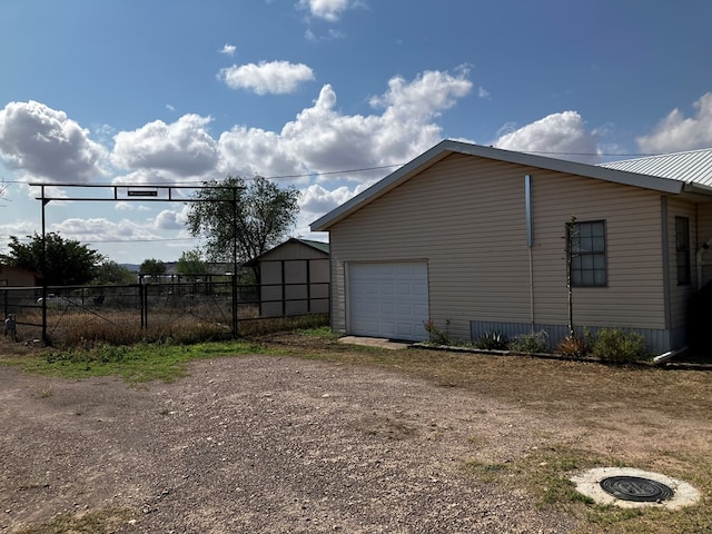 view of side of property featuring an outbuilding and a garage